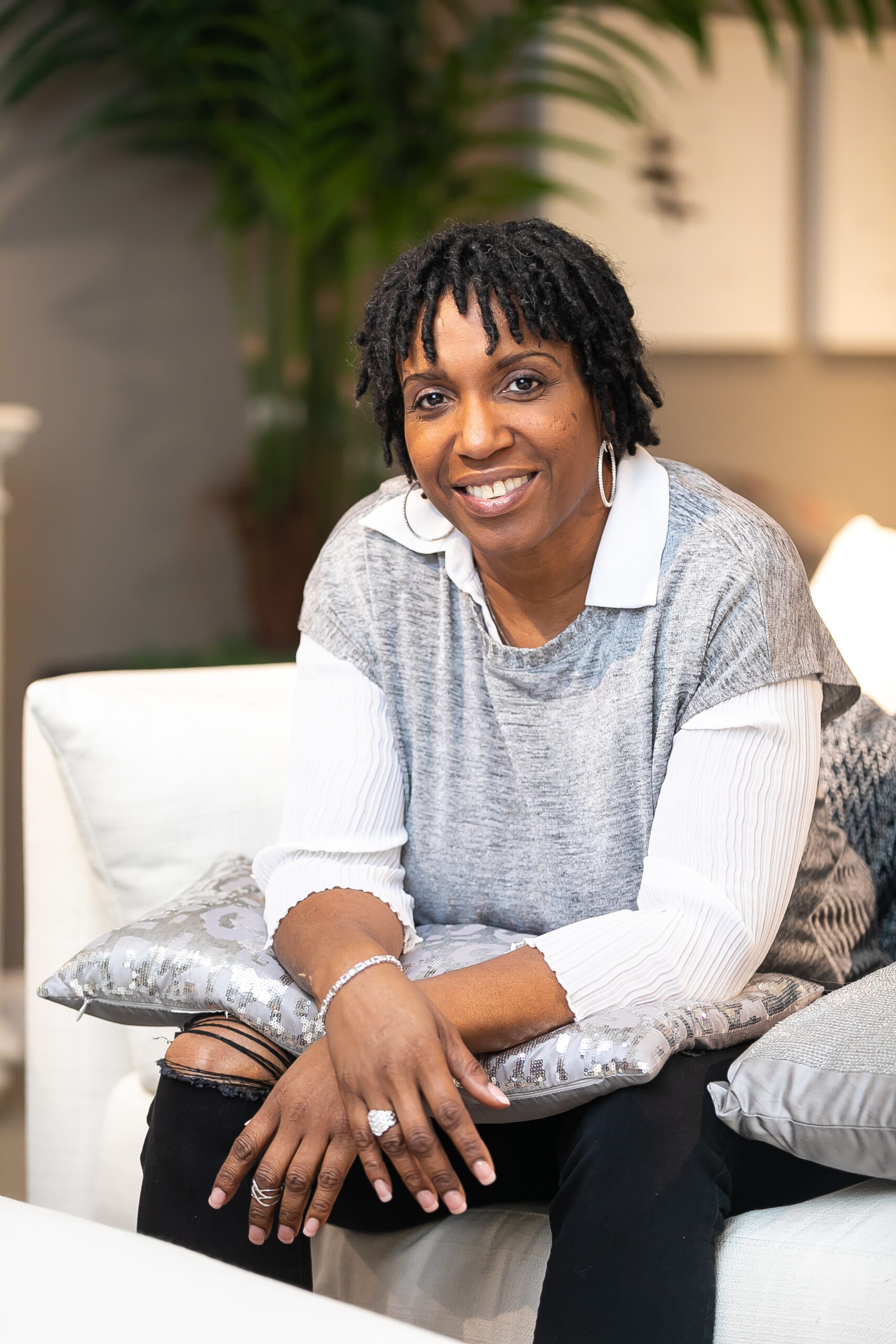 De J. Lozada seated in a relaxed setting